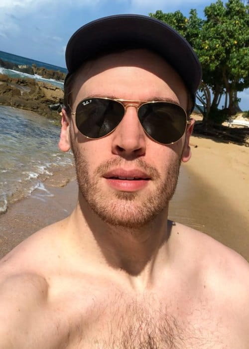 The Capricorn with shirtless tall body on the beach

