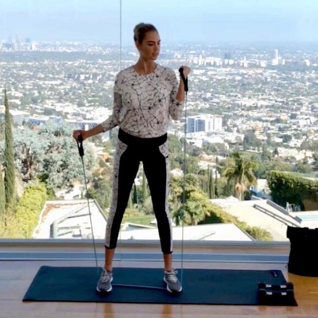 Kate Upton doing exercises using resistance band