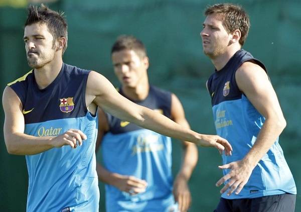David Villa and Lionel Messi warming up before the training session
