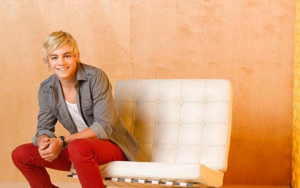 Ross Lynch sitting on the couch or sofa.