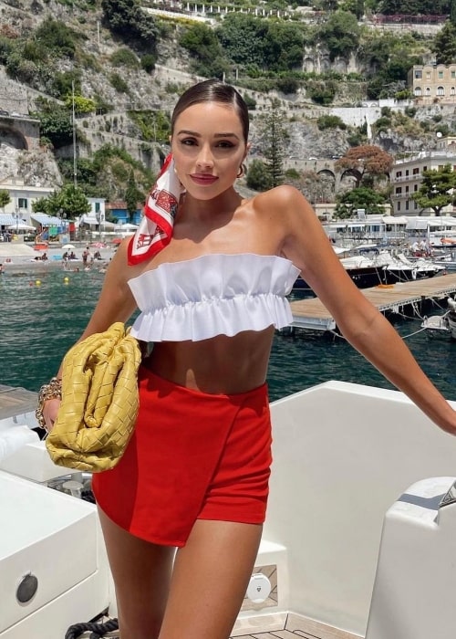 Olivia Culpo posing on a boat in June 2022