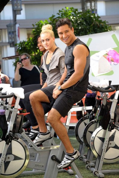 Peta Murgatroyd and Mario Lopez doing spinning workout on the set of Extra