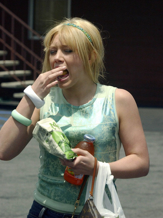 Hilary Duff eating potato chips.