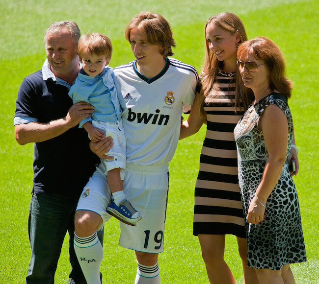 Luka Modric holds his son and poses with his wife Vanja Bosnic and his parents during Luka's presentation as a new Real Madrid player at Estadio Santiago Bernabeu on August 27, 2012 in Madrid, Spain