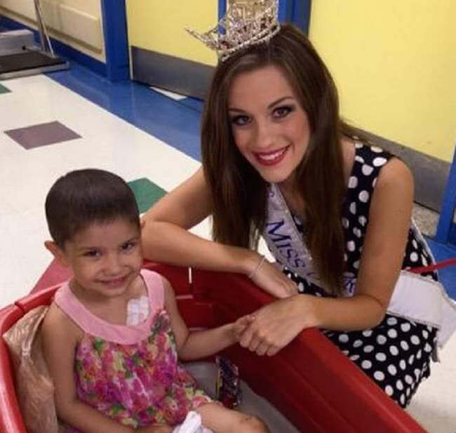 Betty Cantrell with a kid...maybe she is sharing some health advice