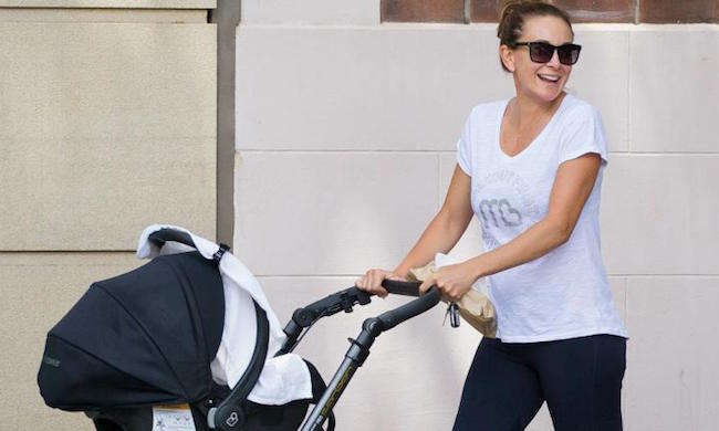 Michelle Bridges walking her son