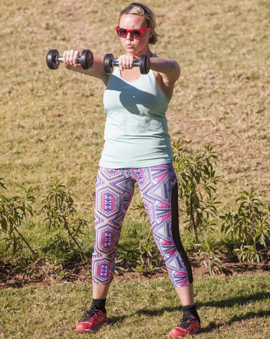 Charlie Brooks doing dumbbell workout during bootcamp