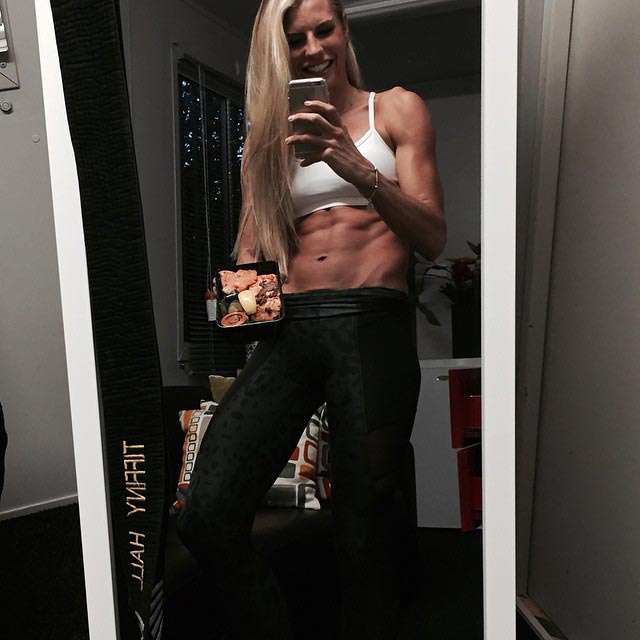 Tiffiny Hall showing her abs