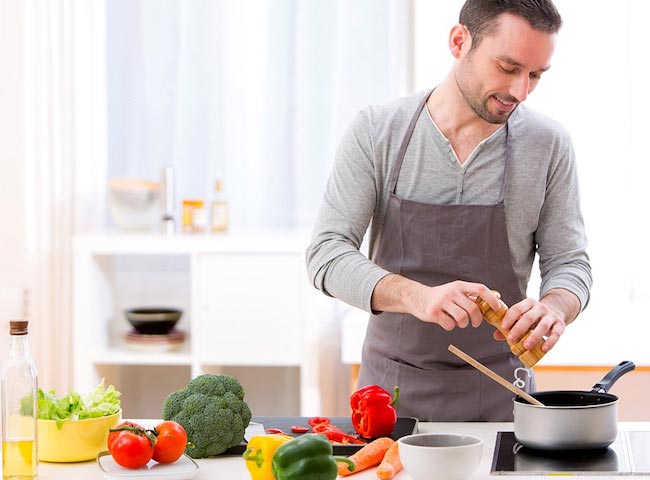 Mark Langowski preparing his food in the kitchen