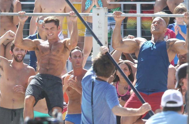 Zac Efron and The Rock during a pull-up contest