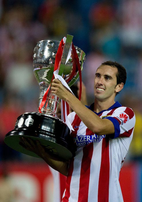 Diego Godin celebrates after winning La Liga Cup trophy after a match against SD Eibar on August 30, 2014