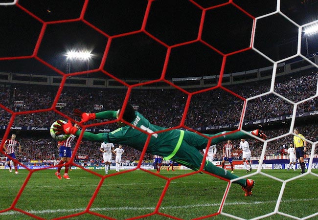 Keylor Navas defending the penalty shot by Atlético Madrid player Antoine Griezmann during a match between Real Madrid CF and Atletico Mardid on October 4, 2015 in Madrid, Spain