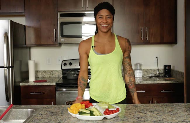 Massy Arias in kitchen having food