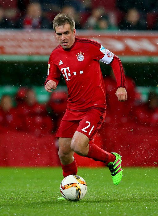 Philipp Lahm handles the ball during a match between Bayern Munich and FC Augsburg on February 14, 2016 in Augsburg, Germany