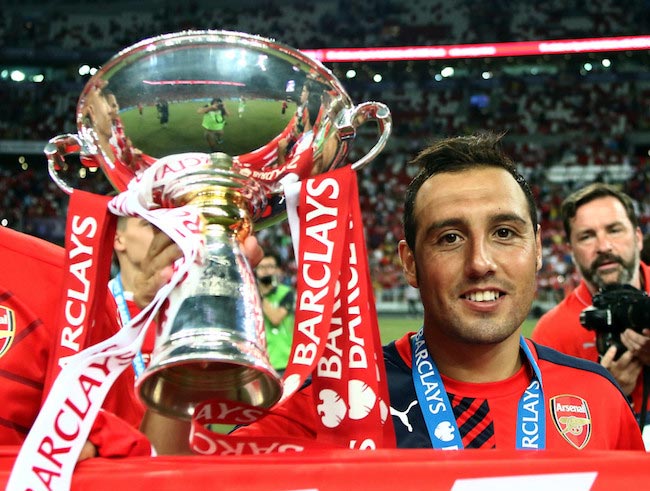 Santi Cazorla celebrates while holding the Barclays Asia Trophy after a win against Everton on July 18, 2015 in Singapore