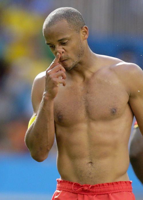 Vincent Kompany showing his ripped body after a match