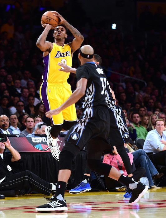 Nick Young drains a three point basket over Karl-Anthony Towns of the Minnesota Timberwolves on October 28, 2015