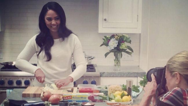 Ayesha Curry chopping vegetables in the kitchen