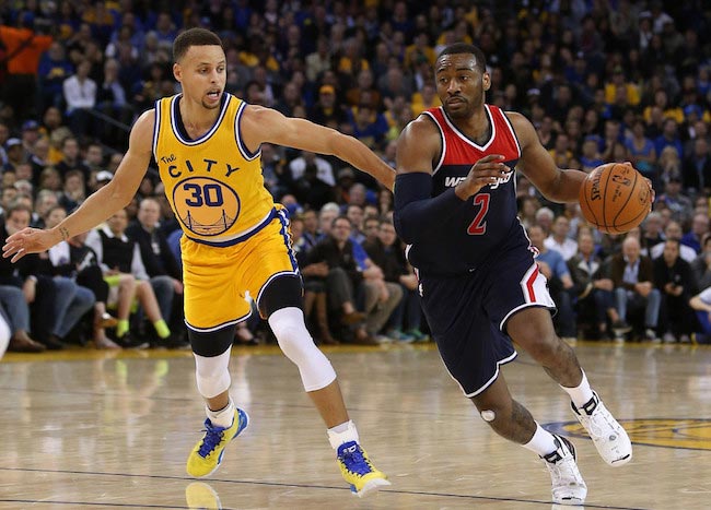 John Wall in action against Stephen Curry on March 29, 2016 in Oakland, California