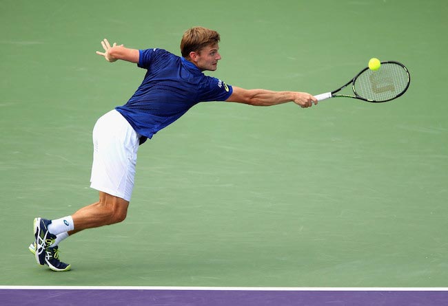 David Goffin tries to return a shot from Gilles Simon during Miami Open on March 30, 2016
