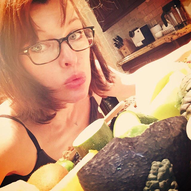 Milla Jovovich having vegetables