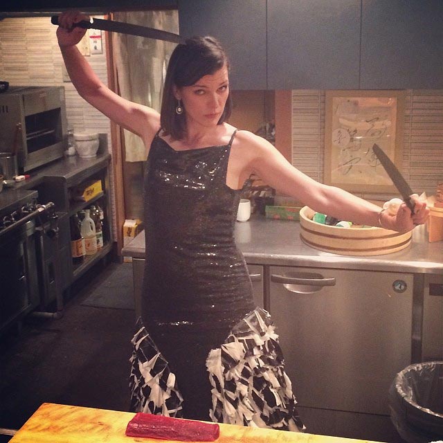 Milla Jovovich with knives in the kitchen