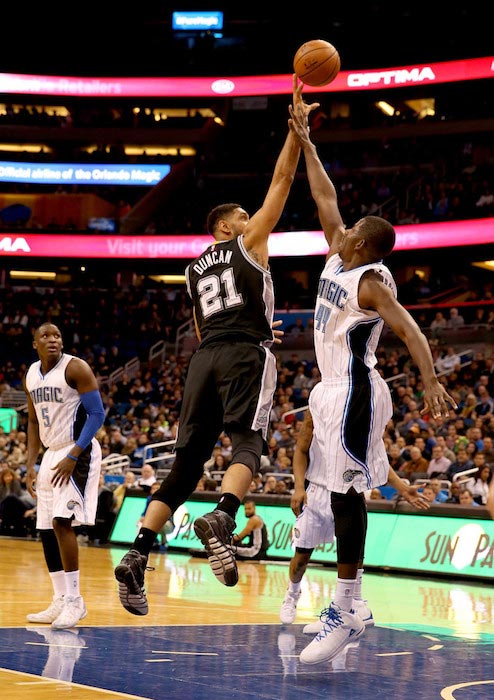 Tim Duncan in a layup attempt over Andrew Nicholson in a match of San Antonio Spurs and Orlando Magic on February 10, 2016