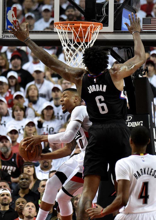 DeAndre Jordan attempts a block on Damian Lillard of Portland Trail Blazers on April 23, 2016