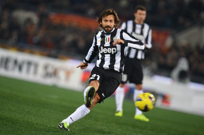 Andrea Pirlo takes a free kick in an away match against AS Roma at Stadio Olympico in February 2013