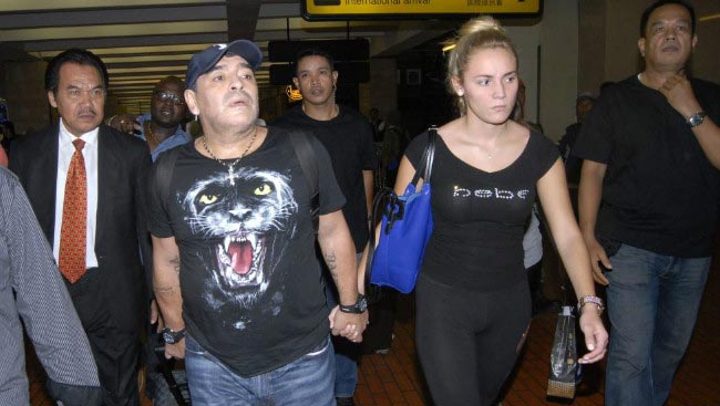 Diego Maradona with girlfriend Rocio Oliva at Buenos Aires airport in 2012