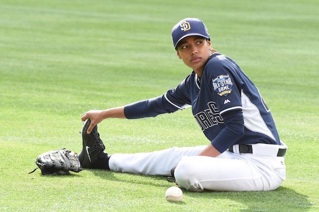 Kylie Bunbury stretching on the field