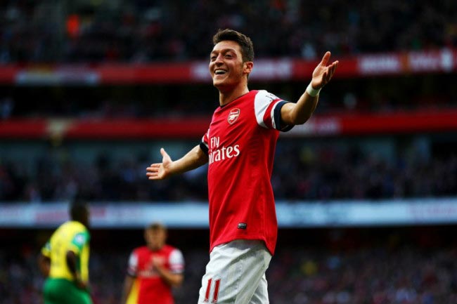 Mesut Özil celebrates after scoring a goal in thumping 4-1 home victory against Norwich in 2013