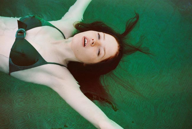 Ellie Bamber in emerald green bikini during an i-D Magazine photoshoot by photographer Angelo Pennetta in April 2015