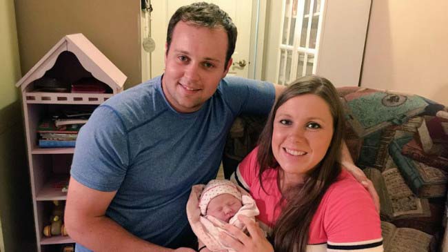 Josh Duggar with wife Anna and their fourth child, a daughter in a picture taken at their home in July 2015