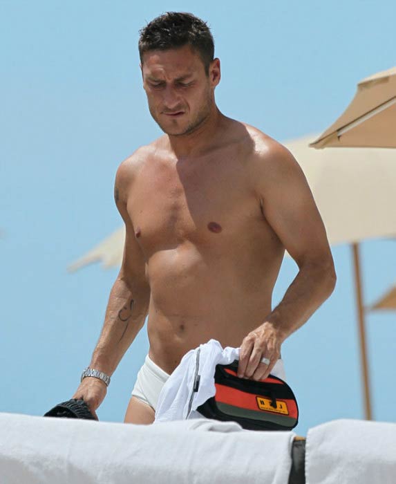 Francesco Totti shirtless relaxes on the beach during summer of 2012