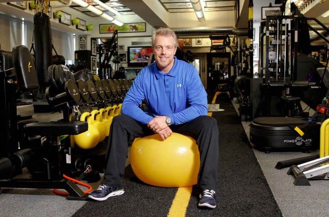 Gunnar Peterson sitting on an exercise ball