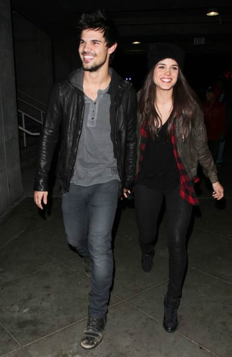 Marie Avgeropoulos and Taylor Lautner at the Jay-Z concert in Los Angeles in December 2013