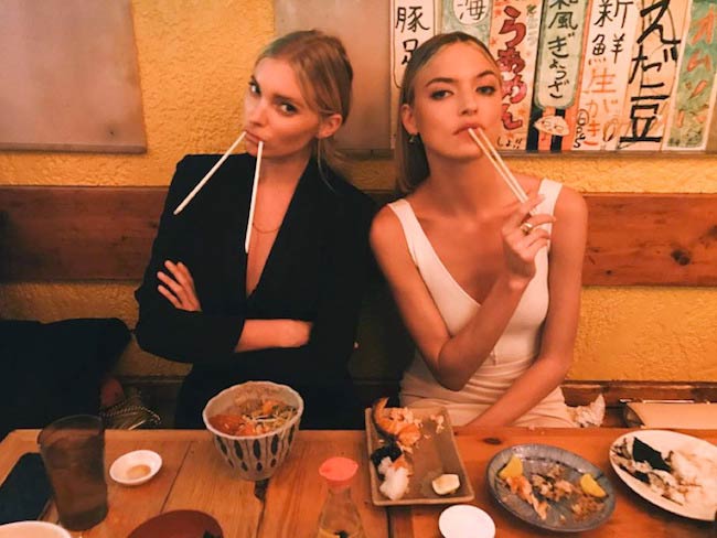 Martha Hunt (Right) having food in a restaurant