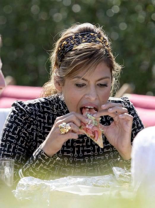 Eva Mendes eating a pizza slice