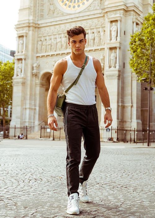 Grayson Dolan shows his ripped arm muscles while a trip to Paris, France in the summer of 2019