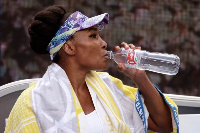 Venus Williams refueling herself with a drink during the match break