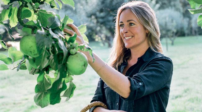 Amelia Freer picking a fruit