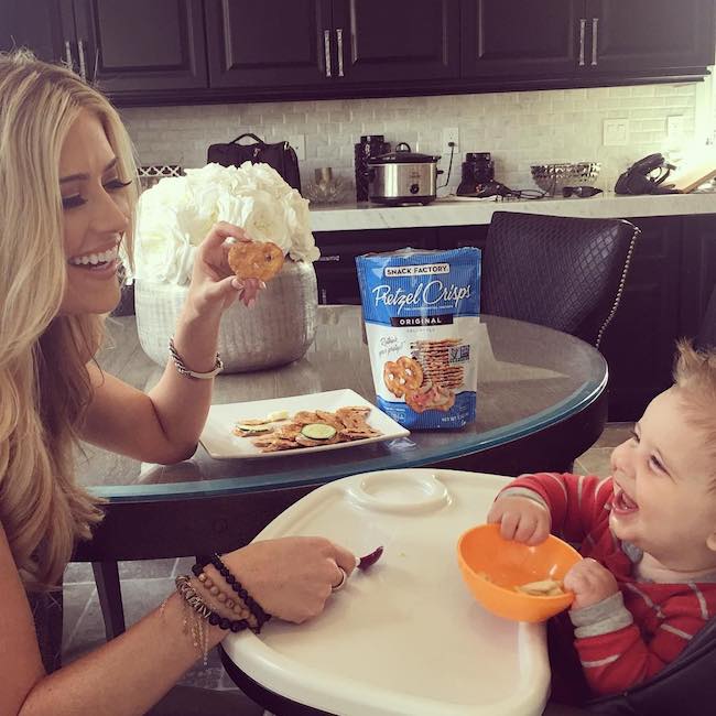 Christina El Moussa and Brayden eating pretzels with hummus