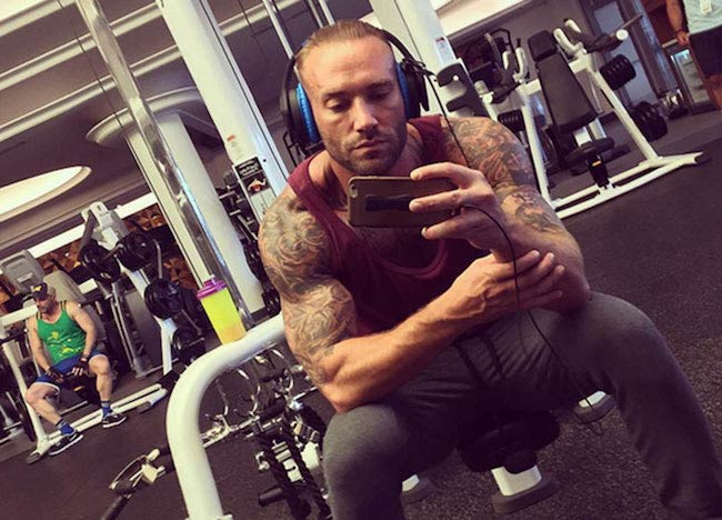 Calum Best checking his phone in the gym