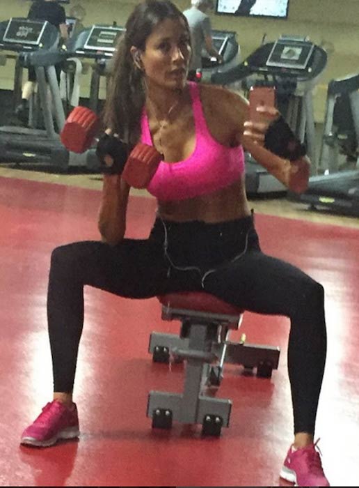 Melanie Sykes doing bicep curls in the gym