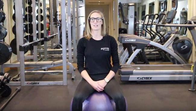 Nicola Addison in her gym sitting on an exercise ball