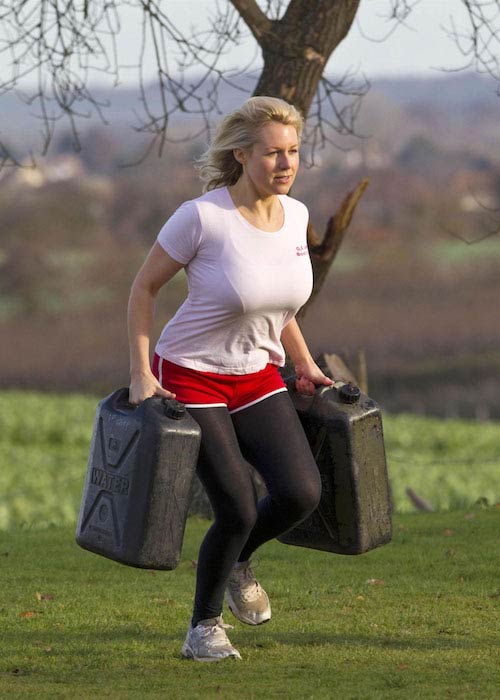 Abi Titmuss carrying weights at a park in London