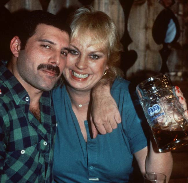 Freddie Mercury and Barbara Valentin poses in a bar