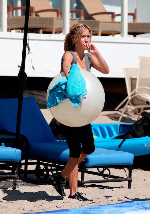 Kristin Cavallari with ball during a beach workout