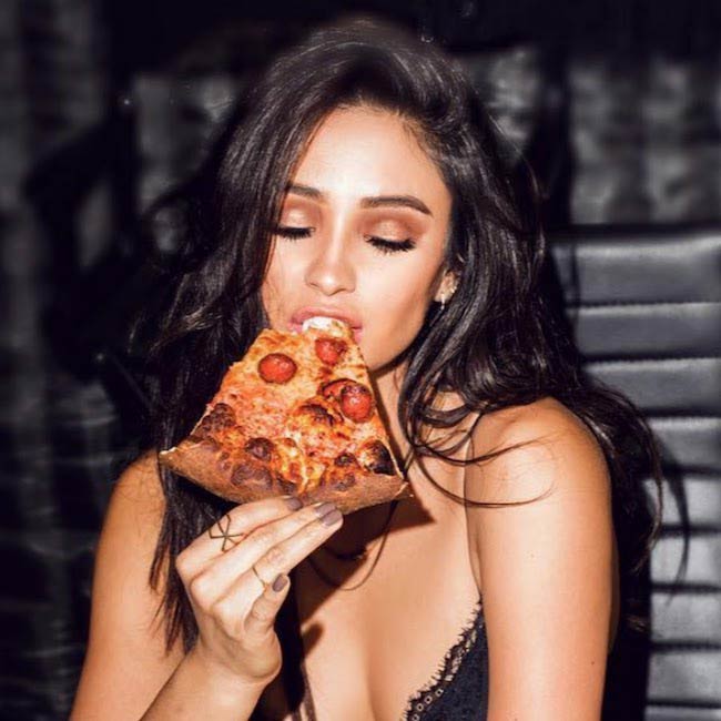 Shay Mitchell relishing pizza